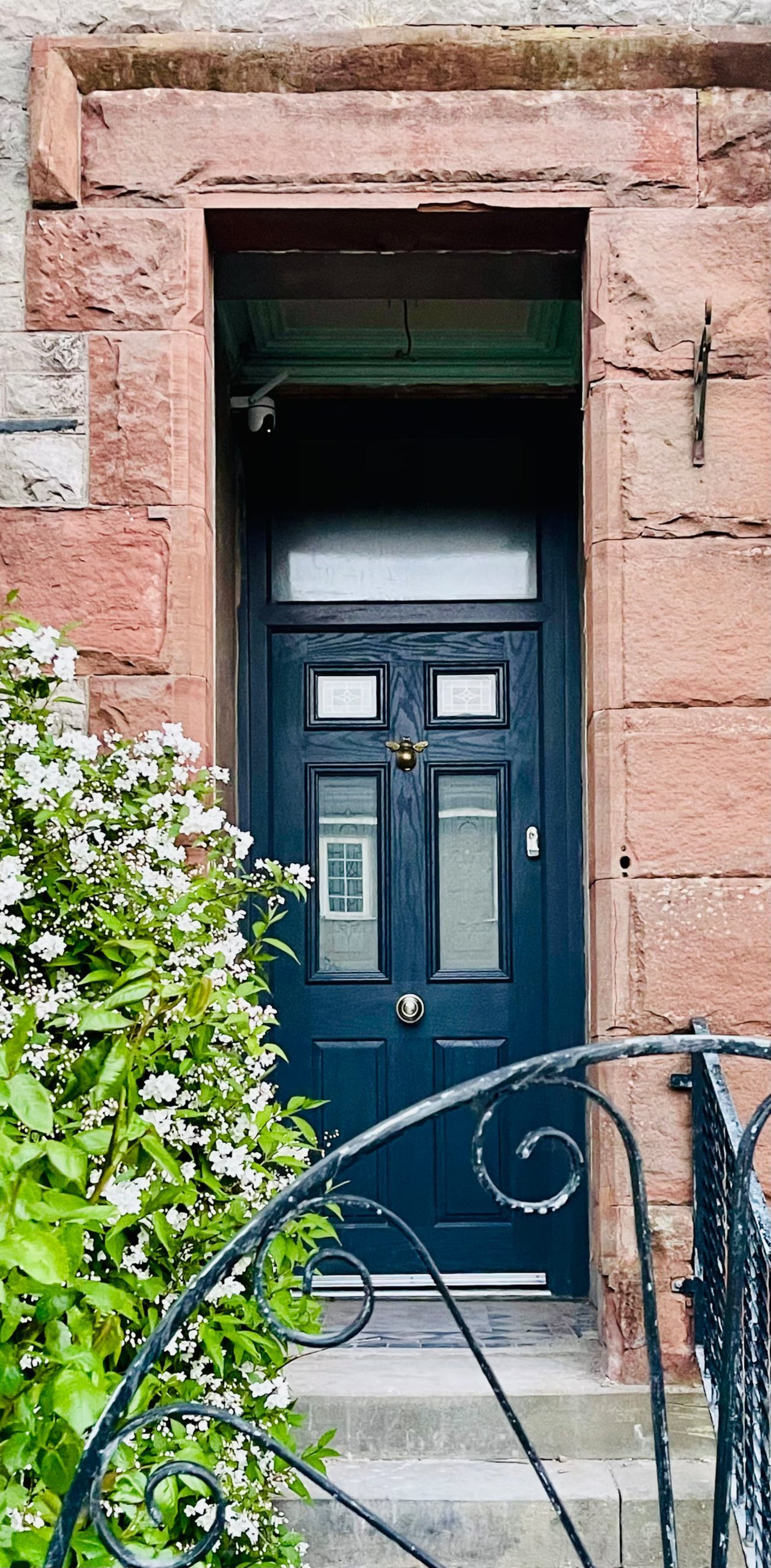 The front door, in red sandstone.